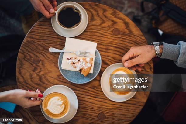 people drinking coffee high angle view - friends toasting above table stock pictures, royalty-free photos & images