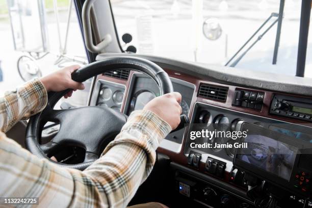 hands of truck driver operating semi-truck - steering wheel foto e immagini stock