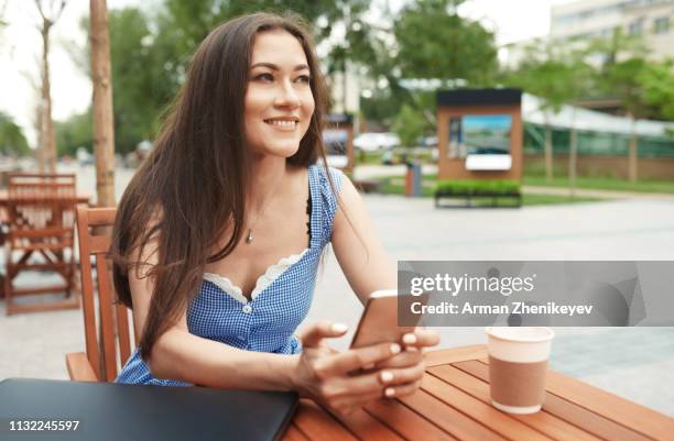 woman sitting at outdoor cafe table - almaty foto e immagini stock