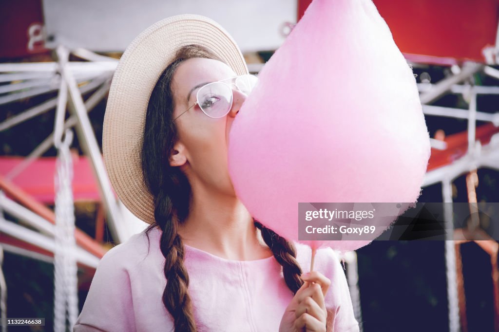 Happy women eating pink cotton candy