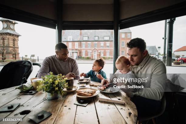 friends sitting in a cafe with their babies - play date stock pictures, royalty-free photos & images
