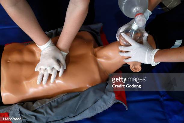 Life-saving first aid on a model. Training session exercise. Heart massage. France.