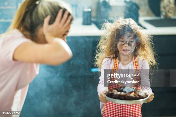 i think the cake was baked a little longer than it should, mommy! - messy cake stock pictures, royalty-free photos & images