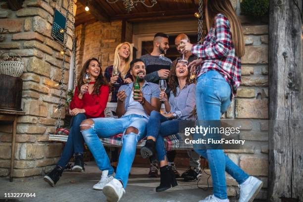 diverse group of people drinking and having fun outdoors - swing chair stock pictures, royalty-free photos & images