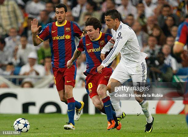 Cristiano Ronaldo of Real Madrid fights for the ball with Lionel Messi of Barcelona during the UEFA Champions League Semi Final first leg match...