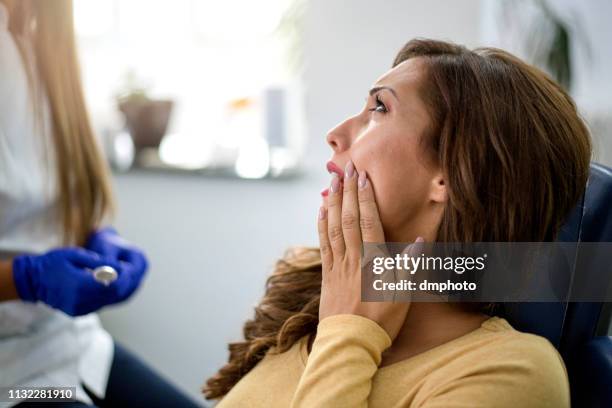 young woman with toothache - toothache stock pictures, royalty-free photos & images