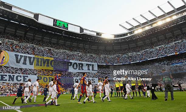 Players from Real Madrid and Barcelona walk on to the pitch prior to the UEFA Champions League Semi Final first leg match between Real Madrid and...