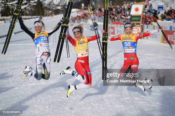 Winner Therese Johaug of Norway celebrates with second placed Frida Karlsson of Sweden and third placed Ingvild Flugstad Oestberg of Norway after the...