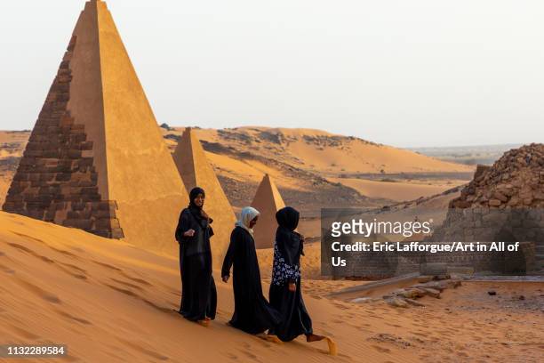 Sudanese women visiting the pyramids of the kushite rulers at Meroe, Northern State, Meroe, Sudan on December 28, 2018 in Meroe, Sudan.