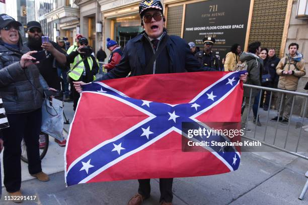 Jovi Val, a local right wing activist, holds a confederate flag during a rally in support of U.S. President Donald Trump near Trump Tower on March...