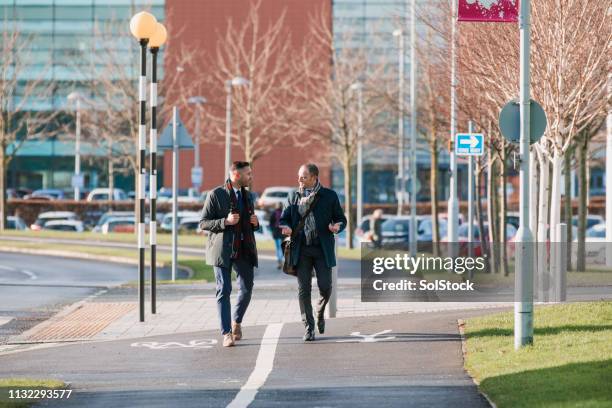 businessmen commuting together - business park uk stock pictures, royalty-free photos & images