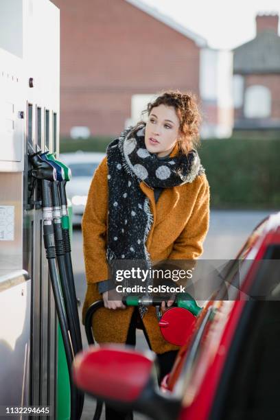 geschäftsfrau füllt ihr auto - diesel kraftstoff stock-fotos und bilder