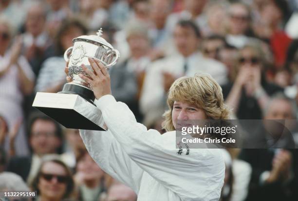 Steffi Graf of Germany celebrates with the Suzanne-Lenglen Cup trophy after winning her Women's Singles Final match against Martina Navratilova at...