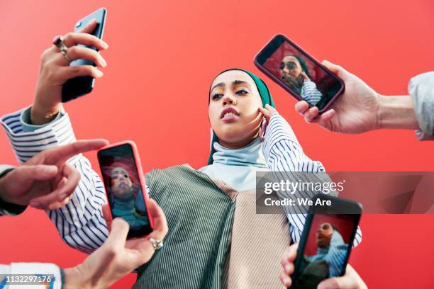 young woman surrounded by smartphones. - reputation ストックフォトと画像