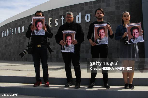 Journalists hold pictures of Mexican colleague Miroslava Breach during a demonstration to mark the second anniversary of her murder, in front of the...
