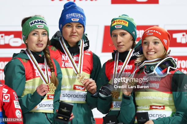 Katharina Althaus, Ramona Straub, Carina Vogt and Juliane Seyfarth of Germany celebrate winning the HS109 women's ski jumping Competition of the FIS...