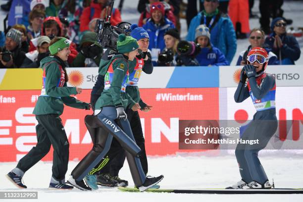 Katharina Althaus of Germany celebrates with team mates Ramona Straub, Juliane Seyfarth and Carina Vogt after winning the HS109 women's ski jumping...