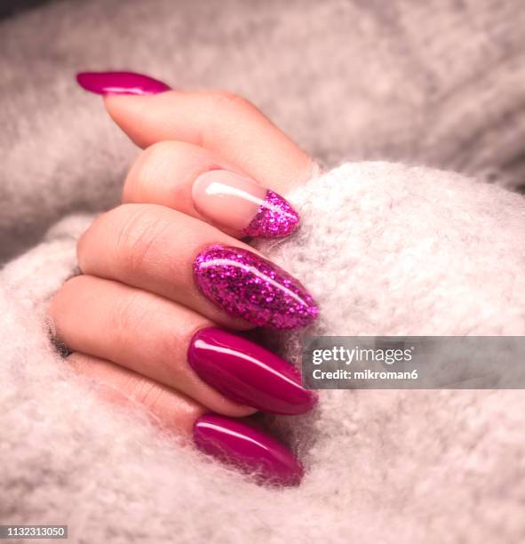 close-up of woman fingers with nail art manicure in pink colour for new years party - artificial nails stock pictures, royalty-free photos & images