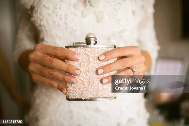 bride holding her pink laced flask - fickplunta bildbanksfoton och bilder