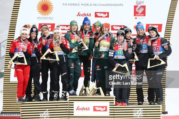 Silver medalists Eva Pinkelnig, Jacqueline Seifriedsberger, Chiara Hoelzl and Daniela Iraschko Stolz of Austria, gold medalists Katharina Althaus,...