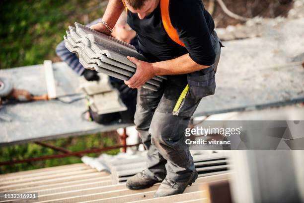 tiling a roof - roofer stock pictures, royalty-free photos & images