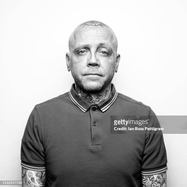 monochrome photo middle-aged punk rocker with tattoos - punk stock pictures, royalty-free photos & images
