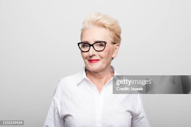 portrait of smiling manager wearing eyeglasses - old woman short hair stock pictures, royalty-free photos & images