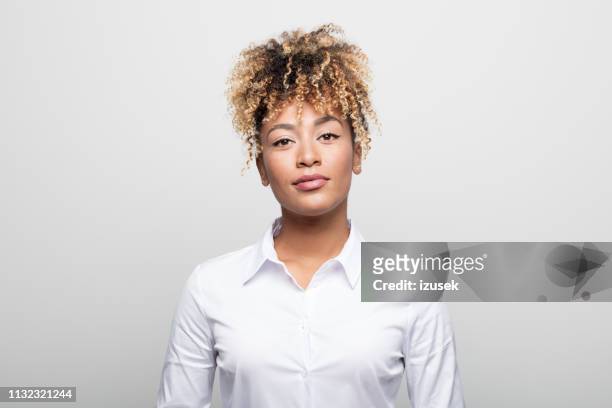 portrait of confident mid adult businesswoman - curly hair woman white shirt stock pictures, royalty-free photos & images
