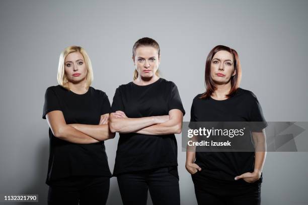 angry mature women wearing black clothing - 40s woman t shirt studio stock pictures, royalty-free photos & images