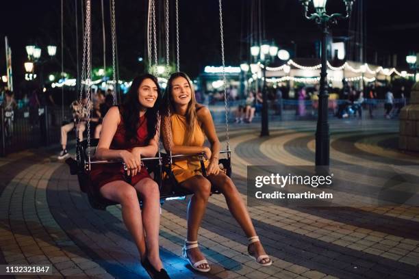 friends having fun at the amusement park - carousel swings stock pictures, royalty-free photos & images