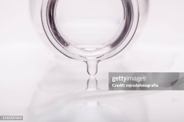 bottle spilling pure water. drop. - botella de agua stock pictures, royalty-free photos & images