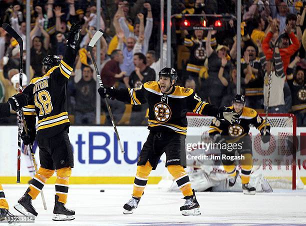 Nathan Horton of the Boston Bruins celebrates with Milan Lucic after Horton scored the winning goal in overtime against the Montreal Canadiens in...