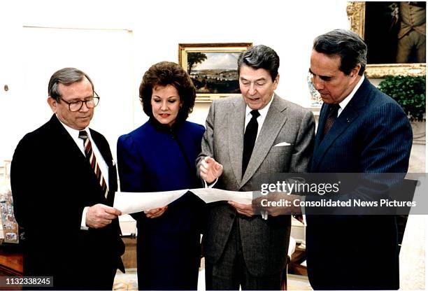 View of, from left, White House Chief of Staff Howard Baker , US Secretary of Transportation Elizabeth Dole, US President Ronald Reagan , and US...