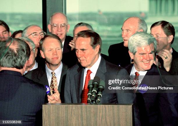 American politician US Senate Majority Leader Bob Dole stands behind the podium during a press conference to announce his resignation from the Senate...