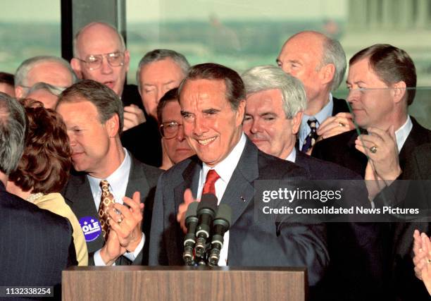 American politician US Senate Majority Leader Bob Dole speaks from the podium during a press conference to announce his resignation from the Senate...