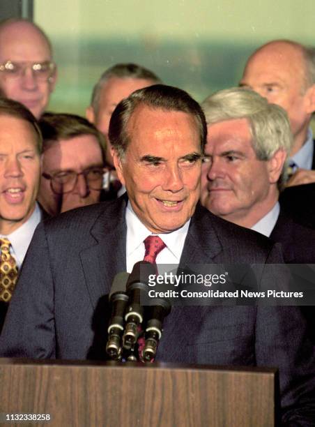 American politician US Senate Majority Leader Bob Dole speaks from the podium during a press conference to announce his resignation from the Senate...
