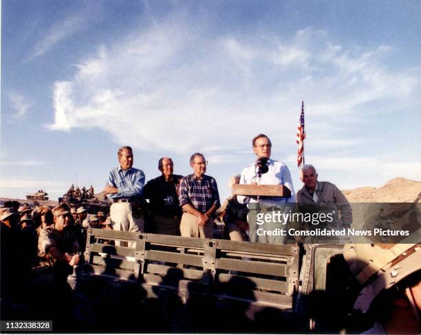 American politician US President George HW Bush speaks to United States military personnel before sharing the holiday meal, Saudi Arabia, November...