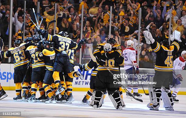 The Boston Bruins celebrate their overtime win against the Montreal Canadiens in Game Seven of the Eastern Conference Quarterfinals during the 2011...