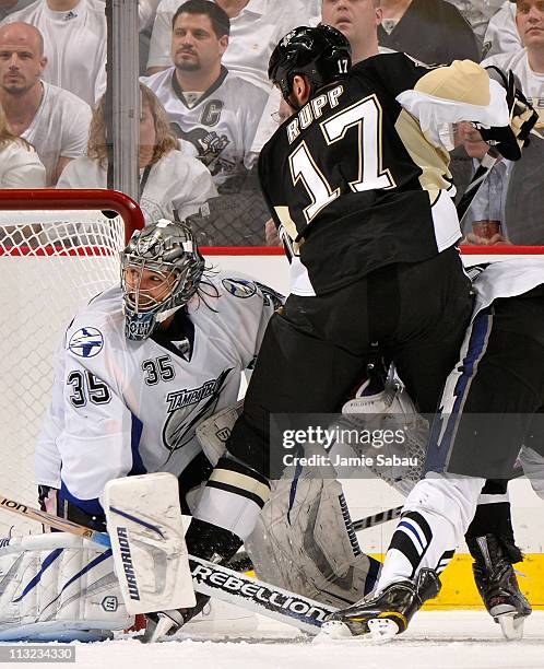 Mike Rupp of the Pittsburgh Penguins battles for position in front of Dwayne Roloson of the Tampa Bay Lightning in Game Seven of the Eastern...