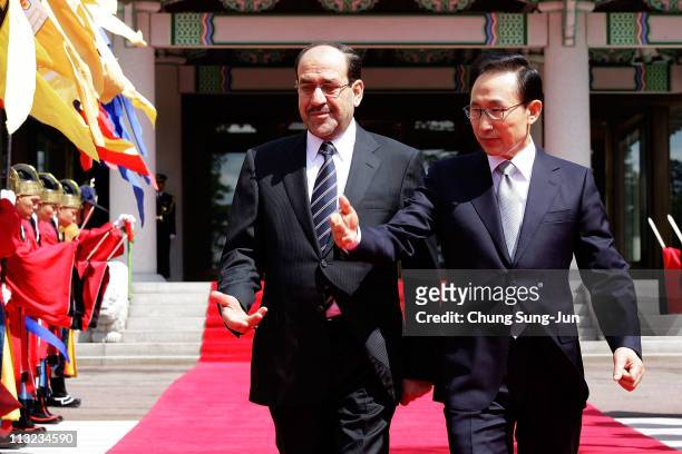 Iraqi Prime Minister Nouri al-Maliki and South Korean President Lee Myung-Bak walk towards a guard of honour during a welcoming ceremony held at the...