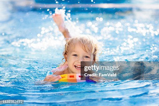 Child learning to swim. Kids in swimming pool. Child learning to swim. Kids in swimming pool.