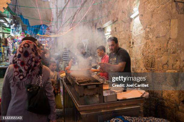 grilled meat for iftar meal in jerusalem's muslim quarter - palestinian clothes stock pictures, royalty-free photos & images