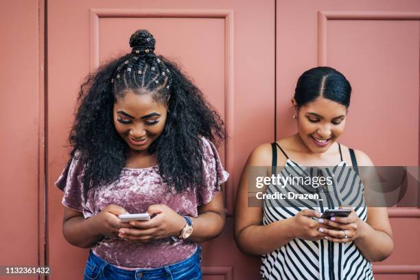 diverse community in usa - dominican woman and her african-american friend - dominican ethnicity stock pictures, royalty-free photos & images