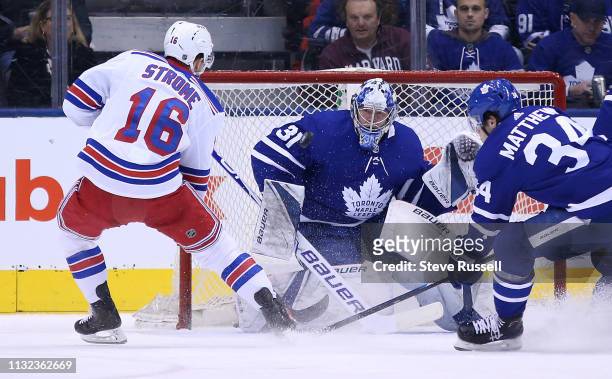Toronto Maple Leafs goaltender Frederik Andersen stops New York Rangers center Ryan Strome as Toronto Maple Leafs center Auston Matthews defends as...