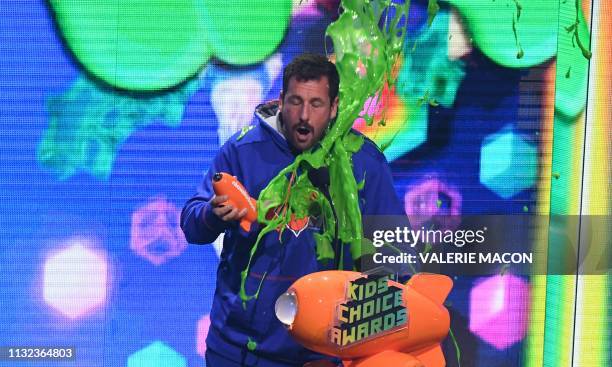 Favorite male voice from an animated movie winner for "Hotel Transylvania 3" actor Adam Sandler gets slimed on stage during the 32nd Annual...