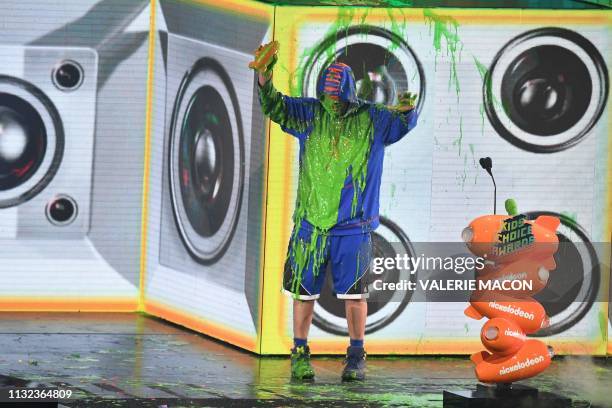 Favorite male voice from an animated movie winner for "Hotel Transylvania 3" actor Adam Sandler gets slimed on stage during the 32nd Annual...