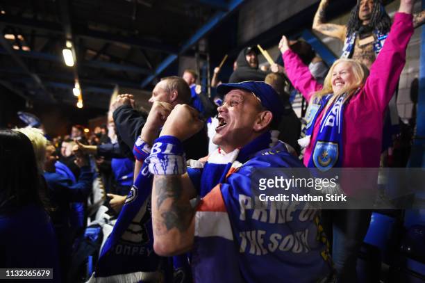 Portsmouth fan celebrates after they score the first goal of the game during the Checkatrade Trophy match between Bury and Portsmouth at Gigg Lane on...
