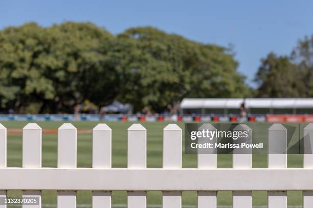 sports field behind white picket fence - estadio de atletismo fotografías e imágenes de stock