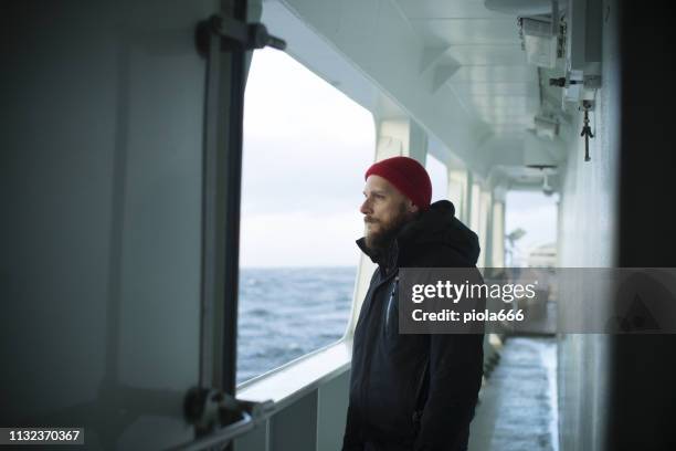 fisher man on the deck of a fishing boat - boat scandinavia stock pictures, royalty-free photos & images