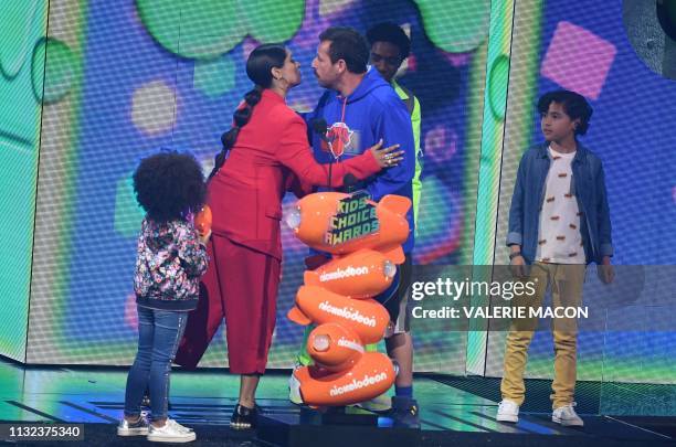 YouTuber Lilly Singh presents Adam Sandler with Favorite male voice from an animated movie award for "Hotel Transylvania 3" on stage during the 32nd...